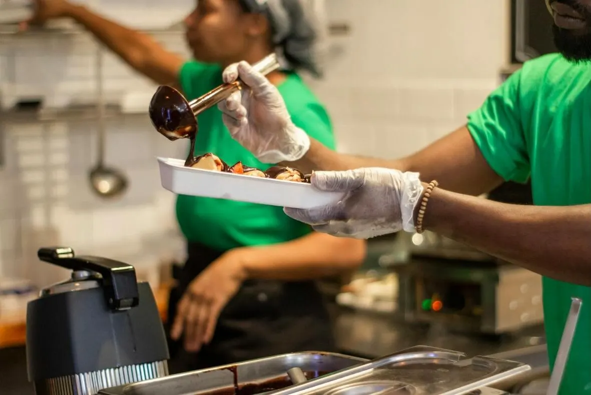 Restaurant staff preparing an order in the kitchen