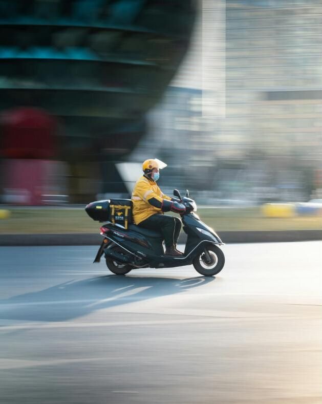 A delivery rider on a scooter